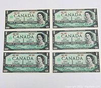 Front side photo of six Canadian $1 banknotes from 1967, showing Queen Elizabeth II portrait and centennial marks.