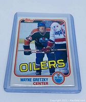 Front of the 1981 Topps Hockey #16 Wayne Gretzky card in a protective plastic sleeve showing player image and team details.