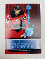 Front side of 2018 Upper Deck Trilogy Rookie Renditions RR-50 Jack Hughes rookie hockey card with red and blue holographic design and Devils team logo.