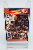 Front photo of the 1984 USA Men's Basketball Michael Jordan Olympic trading card showing Jordan mid-dunk in USA team uniform.