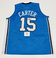 Back view of blue UNC jersey showing “CARTER,” number “15,” autograph on number, PAAS authentication card placed below number.