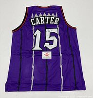Back view of purple Raptors #15 jersey showing CARTER name, signature on number, PAAS sticker attached