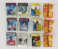 Front view of three sealed 1986 Topps baseball card packs, each with a visible strip showing 48 cards indicated, displaying player images from various teams including Rangers, Mets, Giants, Red Sox, White Sox.