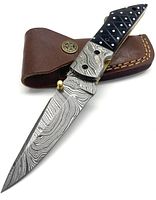 Knife open showing Damascus steel blade and bull horn handle with brass pins.