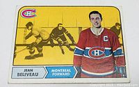 Front side of the 1968 Topps hockey card showing Jean Beliveau in a Montreal Canadiens jersey with a yellow background and logo.