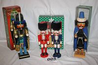 Four wooden nutcrackers displayed with their boxes. Two are taller at 15 inches, and two are shorter at 12 inches.