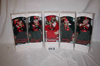 Photo of five boxed Noel Snow Stopper dolls standing upright, showing front view of the dolls and boxes.