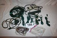 Full lot showing power bars, extension cords including green heavy-duty cord, triple-grounded cord, and several lightweight cords, both grounded and non-grounded.