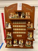 Full front view of the wooden calendar display with all figurines positioned and date blocks arranged.