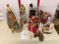 Photo of the full lot showing all Jim Shore figurines, the Gary Patterson skier figurine, and original boxes.