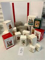 Photo showing multiple Hallmark Magic Keepsake Ornaments in original boxes, with shape and holiday-themed decorations visible on boxes.
