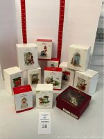All Hallmark Keepsake ornament boxes arranged in a group showing variety of ornaments included in this lot.