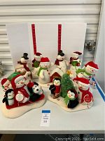 Full set of Hallmark snowmen Christmas figurines on display against white backdrop.