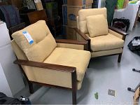 Two armchairs side by side at slight angle showing overall condition