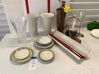 Full lot overview showing vases, plates, glassware and knife on display table