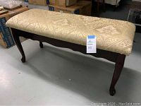 Full side view of wooden bedroom bench showing gold brocade fabric seat and Queen Anne legs.