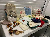 Wide view of table linens including tablecloths, napkins, and decorative napkin rings arranged on a table inside a storage unit