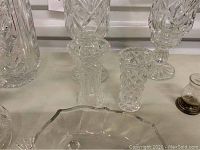 Multiple crystal and glass vases, smaller bowls and dishes shown