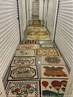 Multiple doormats laid out in hallway showing variety of seasonal and holiday designs including Christmas and Halloween themes, as well as other patterned mats featuring floral and balloon motifs