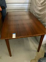 Full view of the teak dining table top in closed position