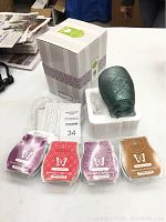 New Scentsy Vintage glass warmer in packaging, four Scentsy wax bars in front in original plastic packaging.