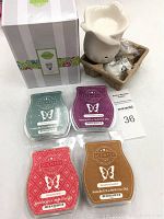 Photo showing white ceramic Scentsy wax warmer and four different Scentsy wax bars