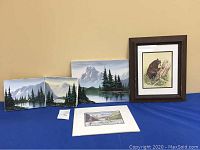 Group of four landscape paintings including three oil paintings and one framed watercolor with bear, plus one unframed print.