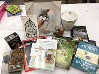 Bird canvas painting, metal wire sun catcher, ceramic jar, and assorted books on birds and nature.
