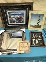 Lot showing all five items: framed beach picture, lighthouse plaque, mirror, dream plaque, and nautical knot shadow box