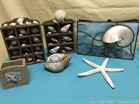 Full lot of six beach-themed decor items on a table.