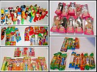 Image showing Pez dispensers in original packaging or sealed wrappers, including cartoon characters and holiday themes.