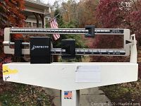 Side view of the DETECTO beam balance patient scale showing the weight measurement component.