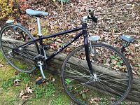 Full side view of the purple Gary Fisher Aquila bicycle with both wheels mounted, showing frame, saddle, pedals, and handlebars.