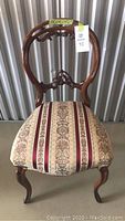 Front view of the Victorian style wooden chair with patterned upholstered seat.