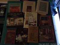 Photo showing most of the set of 10 assorted books on furniture and antiques spread out on a table.