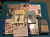 Nine antique and collectable guide books arranged on a table showing various titles and cover images.