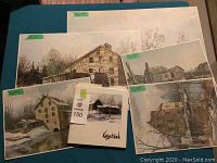 Group of all six pieces arranged on table: five prints plus portfolio sleeve