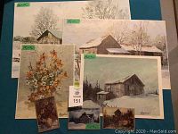 Seven signed Keirstead prints spread on a flat surface showing winter rural cabins and floral still life paintings.