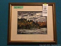 Frontal view of framed painting depicting a lake scene, listing label and auction tag visible