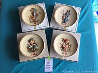 Set of four M.J. Hummel decorative plates, each in original box, showing front designs with years 1983, 1984, 1985, and 1986.