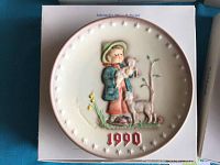 Front view of 1990 M J Hummel decorative plate featuring child with lamb and star border