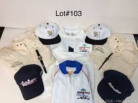 Five jackets and eight baseball style hats arranged flat on white background with lot number text