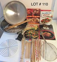 The entire lot shown including the Faberware electric wok bowl, lid, steamer rack, wire racks, wooden chopsticks, bamboo skewers in packaging, metal skimmer, and four Chinese cooking cookbooks arranged on white surface.