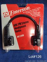 Photo shows Emerson AM/FM Stereo Headphone Radio AR 2200 in original sealed packaging on a red and white cardboard backing, including product features.