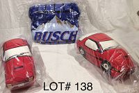 Two red Mazda X-7 car pillows and one inflatable Busch branded car, displayed together sealed in plastic packaging.