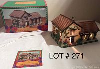 Photo showing the lighted ceramic San Francisco Solano Mission house with original box and accompanying booklet.