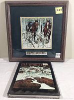 Square wooden framed print by Bev Doolittle showing two horses and rider in a snowy forest scene with small plaque beneath print. Hardcover Bev Doolittle book with snowy forest and horse cover in front of frame on table.