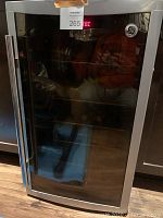 Front view of GE mini refrigerator with tinted glass door, stainless steel frame and vertical handle
