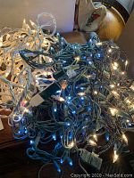 Tangled strings of multicolor LED and traditional incandescent lights illuminated to show functionality.