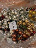 Close-up view of assorted Christmas decorative picks with small ball ornaments in silver, gold, bronze colors and red berry accents.